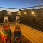 Evening deck with string lights and drinks